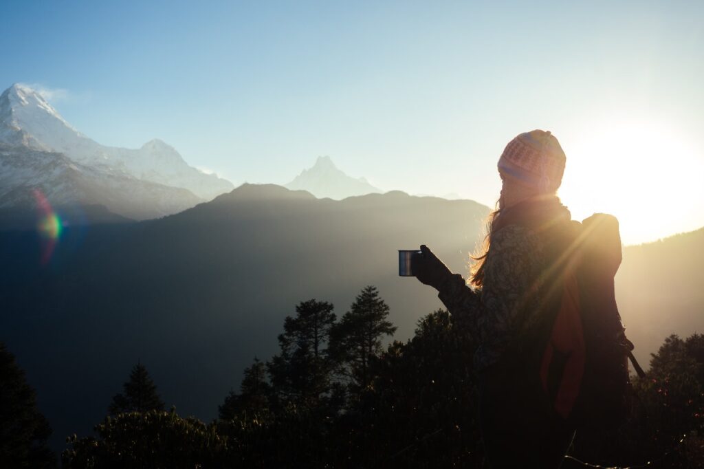 Trekkers watching sunrise from Ghorepani Poon Hill Trek with Annapurna and Dhaulagiri ranges in the background