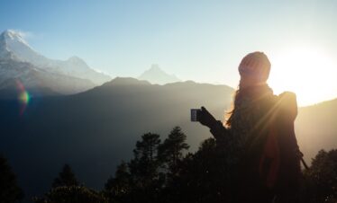 Trekkers watching sunrise from Ghorepani Poon Hill Trek with Annapurna and Dhaulagiri ranges in the background
