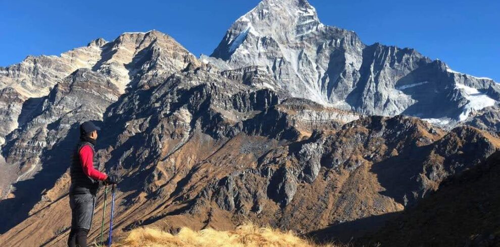 yoga trekker enjoying mountain views on Mardi Himal Trek