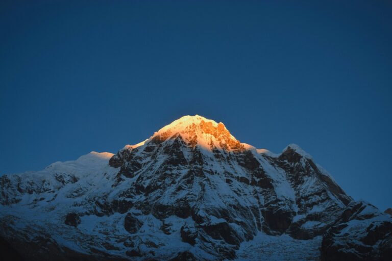 Panoramic view of Annapurna Base Camp Trek with clear skies during peak trekking season from Dubai travelers’ perspective