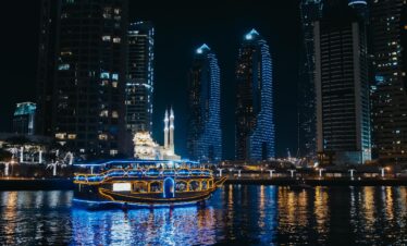Dubai skyline illuminated as seen from a dhow cruise on Dubai Creek