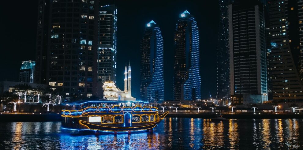 Dubai skyline illuminated as seen from a dhow cruise on Dubai Creek
