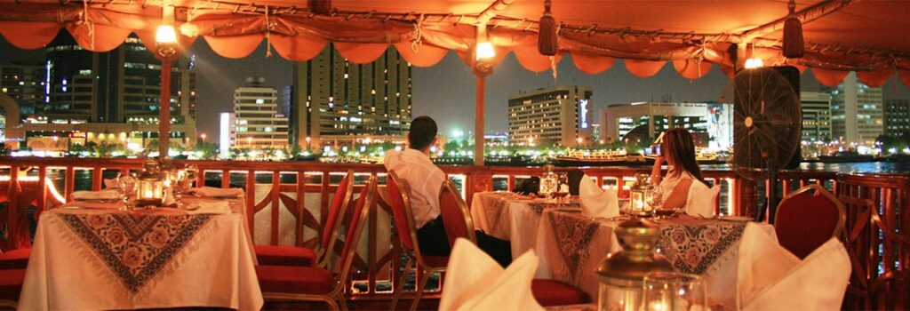 Romantic evening on a Dubai Marina dhow cruise with candle-lit tables