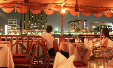 Romantic evening on a Dubai Marina dhow cruise with candle-lit tables