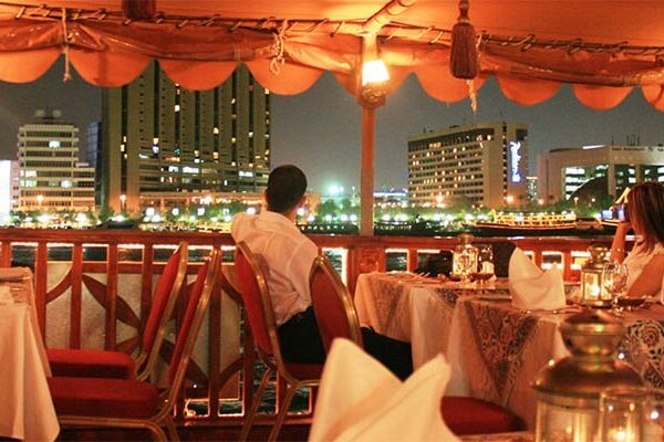 Romantic evening on a Dubai Marina dhow cruise with candle-lit tables