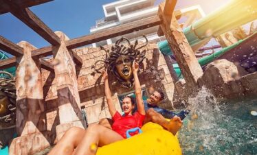Thrill-seekers on a high-speed water ride at Atlantis Dubai Waterpark