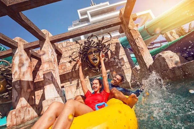Thrill-seekers on a high-speed water ride at Atlantis Dubai Waterpark