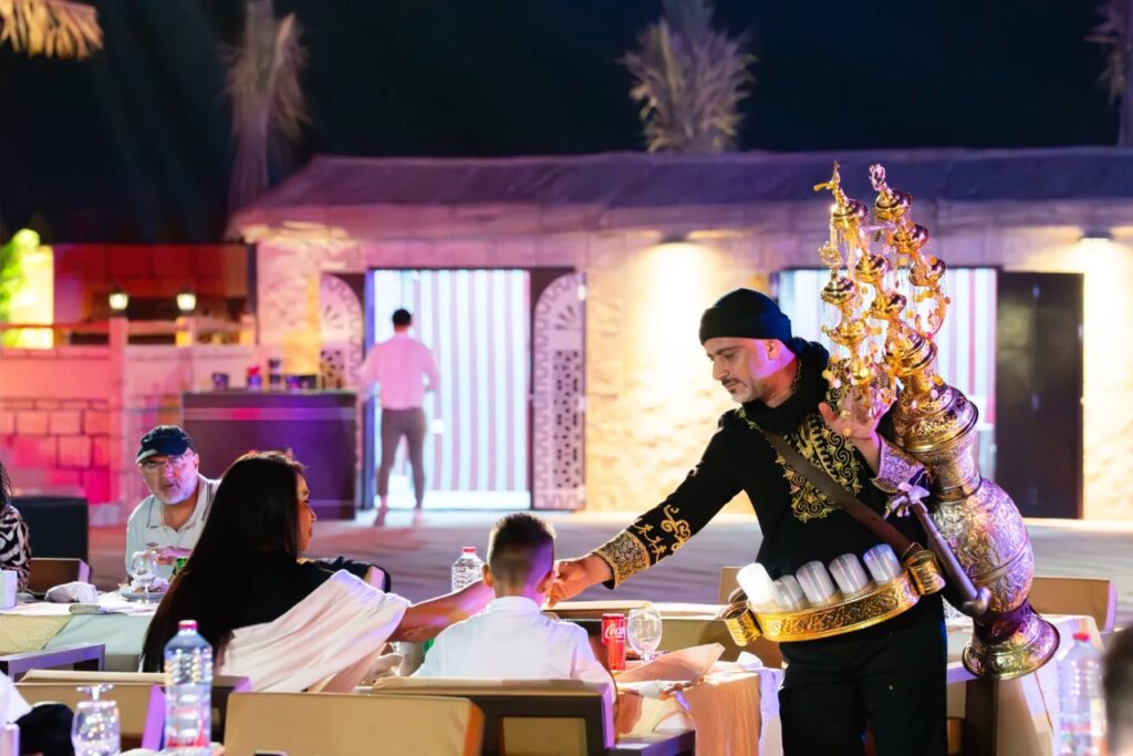 Tourists enjoying a premium private evening desert safari in Dubai with sunset views