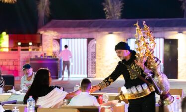 Tourists enjoying a premium private evening desert safari in Dubai with sunset views
