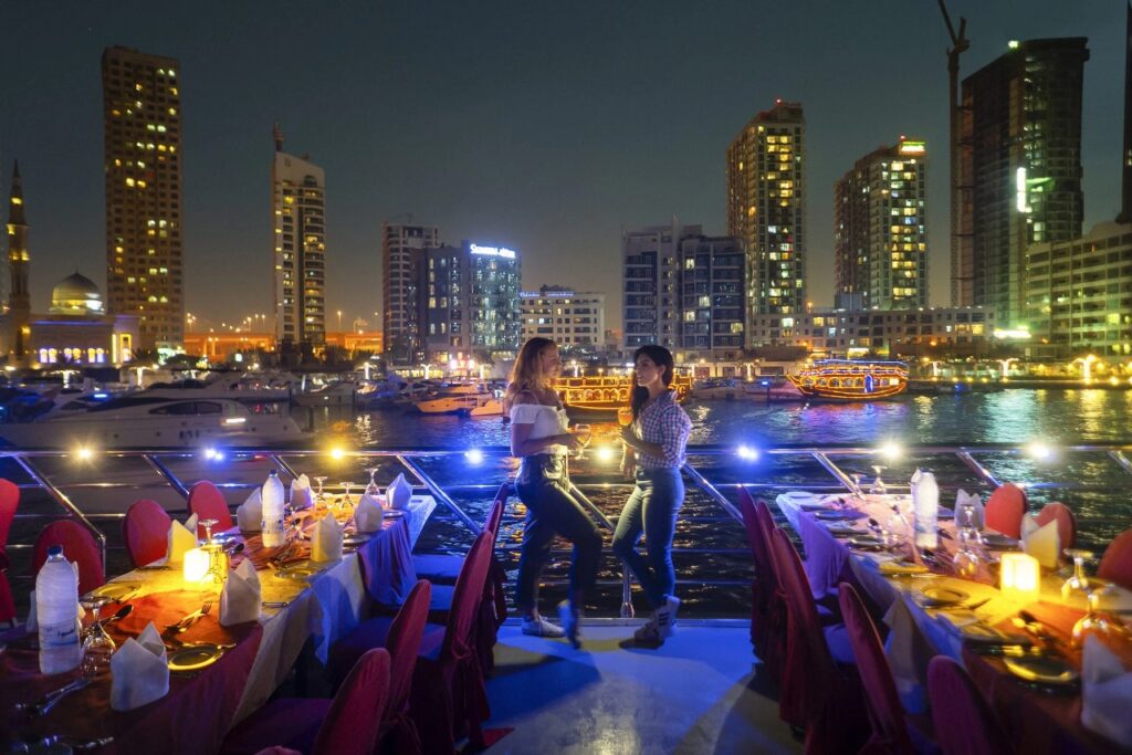 Tourists standing and posing for a photo on Dubai Marina dhow cruise