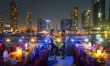 Tourists standing and posing for a photo on Dubai Marina dhow cruise