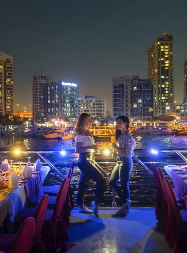 Tourists standing and posing for a photo on Dubai Marina dhow cruise
