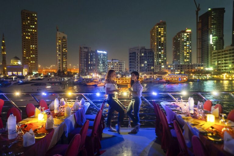 Tourists standing and posing for a photo on Dubai Marina dhow cruise