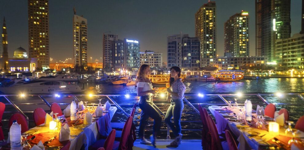 Tourists standing and posing for a photo on Dubai Marina dhow cruise