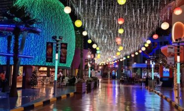 Tourists walking inside IMG Boulevard at IMG Worlds of Adventure