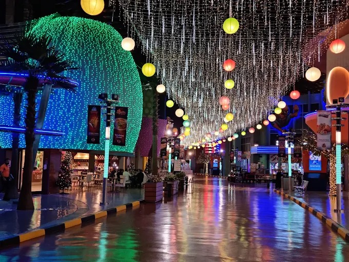 Tourists walking inside IMG Boulevard at IMG Worlds of Adventure