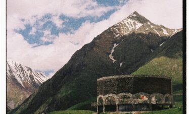 Tourist exploring Vardzia cave monastery carved into the cliffs