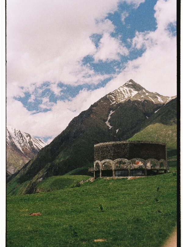 Tourist exploring Vardzia cave monastery carved into the cliffs