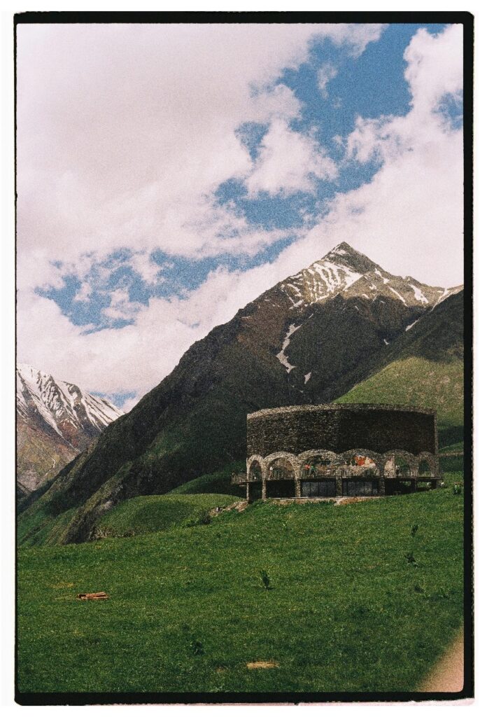 Tourist exploring Vardzia cave monastery carved into the cliffs